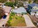 An aerial view of a charming green single-Gathering home with mature landscaping, a gray roof, and a brick paver driveway at 263 42Nd Ne Ave, St Petersburg, FL 33703