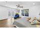 Bright bedroom with wood floors, ceiling fan, doors to the exterior, and a large window at 263 42Nd Ne Ave, St Petersburg, FL 33703