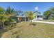 Charming home boasting a lush front yard with mature trees and landscaping at 263 42Nd Ne Ave, St Petersburg, FL 33703