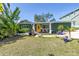 Charming home with a bright yellow door, surrounded by lush landscaping, and complemented by stylish white window shutters at 263 42Nd Ne Ave, St Petersburg, FL 33703