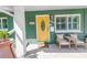 Inviting front porch with seating area and bright yellow door at 263 42Nd Ne Ave, St Petersburg, FL 33703