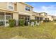 The rear of this home features screened patios, a grill, and a spacious yard at 31211 Gossamer Way, Wesley Chapel, FL 33543