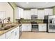 Bright kitchen with white cabinets, stainless steel appliances, and granite countertops at 31211 Gossamer Way, Wesley Chapel, FL 33543