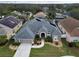 A stunning aerial view of the home, showcasing its well-kept lawn and landscaping, in a friendly neighborhood at 5206 Whispering Leaf Trl, Valrico, FL 33596