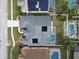 Bird's-eye view of home with solar panels, screened pool, and well-manicured landscaping in a neighborhood at 5206 Whispering Leaf Trl, Valrico, FL 33596