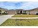 A charming home featuring a meticulously landscaped yard, inviting entrance, and a neatly paved driveway at 5206 Whispering Leaf Trl, Valrico, FL 33596