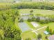Aerial view of sports park, including basketball and volleyball courts, surrounded by lush trees at 5809 War Admiral Dr, Wesley Chapel, FL 33544