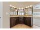 A bathroom features dark cabinets and granite counters at 5809 War Admiral Dr, Wesley Chapel, FL 33544