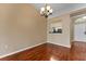 Inviting dining area with hardwood floors, natural light, and a view to the kitchen at 5809 War Admiral Dr, Wesley Chapel, FL 33544