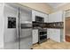 Modern kitchen featuring stainless steel appliances, including a double oven, microwave, and refrigerator at 5809 War Admiral Dr, Wesley Chapel, FL 33544
