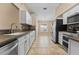 Bright kitchen with stainless steel appliances, white cabinets, tile backsplash and ample counter space at 5809 War Admiral Dr, Wesley Chapel, FL 33544