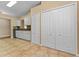 Open kitchen with modern white cabinets, tile floors, and adjacent closet space at 5809 War Admiral Dr, Wesley Chapel, FL 33544