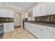 Well-equipped kitchen featuring tile flooring, countertops and ample white cabinetry for storage at 5809 War Admiral Dr, Wesley Chapel, FL 33544