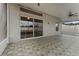 Enclosed patio with ceiling fan and sliding glass doors to backyard at 5809 War Admiral Dr, Wesley Chapel, FL 33544