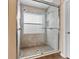 A walk in shower features stylish tile and a glass door at 5809 War Admiral Dr, Wesley Chapel, FL 33544