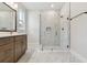Modern bathroom featuring a glass shower, marble tile, and vanity with bronze fixtures at 687 Allora Ave, Nokomis, FL 34275