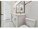 Bathroom with double sink vanity, marble floors, and modern fixtures at 687 Allora Ave, Nokomis, FL 34275