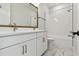 Modern bathroom featuring a double vanity with white cabinets and marble floors at 687 Allora Ave, Nokomis, FL 34275