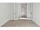Bright, empty bedroom featuring French doors and new laminate flooring at 687 Allora Ave, Nokomis, FL 34275