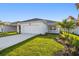Front exterior of a modern home with manicured lawn and landscaping at 687 Allora Ave, Nokomis, FL 34275