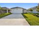 Modern home exterior with a wide driveway and lush green lawn at 687 Allora Ave, Nokomis, FL 34275