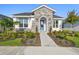 Beautiful one-story home featuring stone accents, manicured landscaping, and a welcoming blue front door at 687 Allora Ave, Nokomis, FL 34275