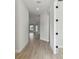 Bright hallway featuring new laminate flooring and neutral paint, leading to various rooms in the home at 687 Allora Ave, Nokomis, FL 34275