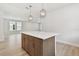 Open kitchen boasts a quartz countertop island with pendant lighting at 687 Allora Ave, Nokomis, FL 34275