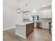 Bright kitchen boasts a central island with quartz countertops, stainless appliances, and modern pendant lighting at 687 Allora Ave, Nokomis, FL 34275