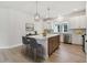 Bright kitchen featuring a center island, modern appliances, pendant lights, and ample cabinet space at 687 Allora Ave, Nokomis, FL 34275