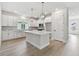 Modern kitchen featuring white cabinetry, stainless steel appliances, a large island, and stylish pendant lighting at 687 Allora Ave, Nokomis, FL 34275