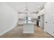 Bright kitchen featuring white cabinets, stainless appliances, a quartz island and modern pendant lighting at 687 Allora Ave, Nokomis, FL 34275