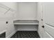 Laundry room with granite counters, overhead shelving, and sleek black floors at 687 Allora Ave, Nokomis, FL 34275
