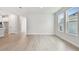 Open floorplan living room features wood floors and multiple windows for ample natural light at 687 Allora Ave, Nokomis, FL 34275