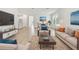 Spacious living room with hardwood floors, comfortable seating, and large windows offering natural light at 687 Allora Ave, Nokomis, FL 34275