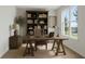 Cozy home office with a large window for natural light, built-in shelving, and a comfortable desk at 687 Allora Ave, Nokomis, FL 34275