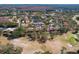 Expansive aerial view of the community showcasing townhomes, water features, golf course, and natural surroundings at 3505 Tarpon Woods Blvd # K406, Palm Harbor, FL 34685