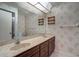 Bathroom featuring a dual sink vanity with a large mirror and bright lighting at 3505 Tarpon Woods Blvd # K406, Palm Harbor, FL 34685