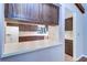 Bright kitchen with white appliances and warm wood cabinetry, viewed through a pass-through from living area at 3505 Tarpon Woods Blvd # K406, Palm Harbor, FL 34685
