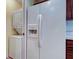 Bright kitchen features a full-sized refrigerator, and a washer/dryer closet at 3505 Tarpon Woods Blvd # K406, Palm Harbor, FL 34685