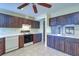 Cozy kitchen features brown cabinets, white countertops, tile floors, and modern appliances at 3505 Tarpon Woods Blvd # K406, Palm Harbor, FL 34685