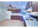Cozy kitchen features brown cabinets, white countertops, tile floors, and modern appliances at 3505 Tarpon Woods Blvd # K406, Palm Harbor, FL 34685