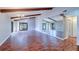 Spacious living room featuring vaulted ceilings, wood beams, hardwood floors, and sliding glass doors at 3505 Tarpon Woods Blvd # K406, Palm Harbor, FL 34685