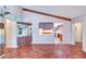 Living room featuring hardwood floors, vaulted ceilings with wood beams, a wet bar, and pass-through kitchen at 3505 Tarpon Woods Blvd # K406, Palm Harbor, FL 34685