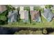 An aerial view of backyard pools with screened enclosures, beautiful landscaping and a nearby lake at 10025 Cypress Shadow Ave, Tampa, FL 33647