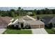 Charming single-story home with a three-car garage, manicured lawn, and beautiful landscaping at 10025 Cypress Shadow Ave, Tampa, FL 33647