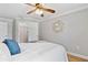 Light bedroom featuring a ceiling fan, walk-in closet, and natural light from a window at 10079 83Rd Way, Seminole, FL 33777