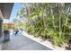 Backyard featuring brick-paved patio and lush tropical landscaping at 1309 Nokomis S Ave, Venice, FL 34285
