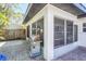 Outdoor patio area with a stainless steel grill, surrounded by lush landscaping and privacy at 1309 Nokomis S Ave, Venice, FL 34285