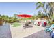 Outdoor patio area includes a pool, a red umbrella, and lush tropical landscaping at 1309 Nokomis S Ave, Venice, FL 34285